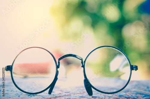 Artwork in retro style, Spectacles and book , vintage styled,selective focus