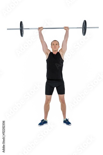 Bodybuilder lifting heavy barbell weights on white background