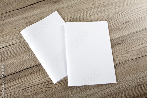 Blank catalog, brochure, magazines, book on wooden background
