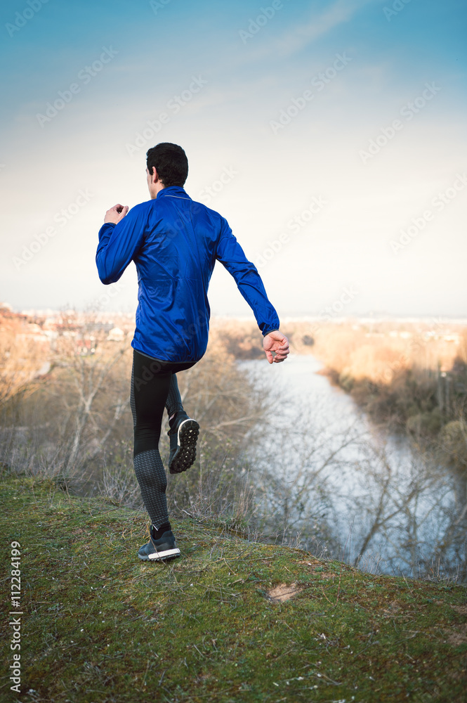 Man running in a promenade outdoors. Man is training Man running in a promenade outdoors. Man is training