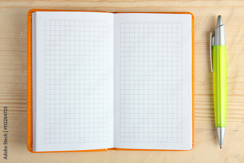 orange notebook on a white wooden background with handle orange notebook on a white wooden background with handle