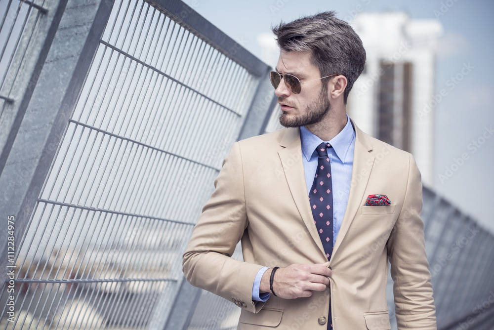 Handsome man in bright suit against the city Handsome man in bright suit against the city