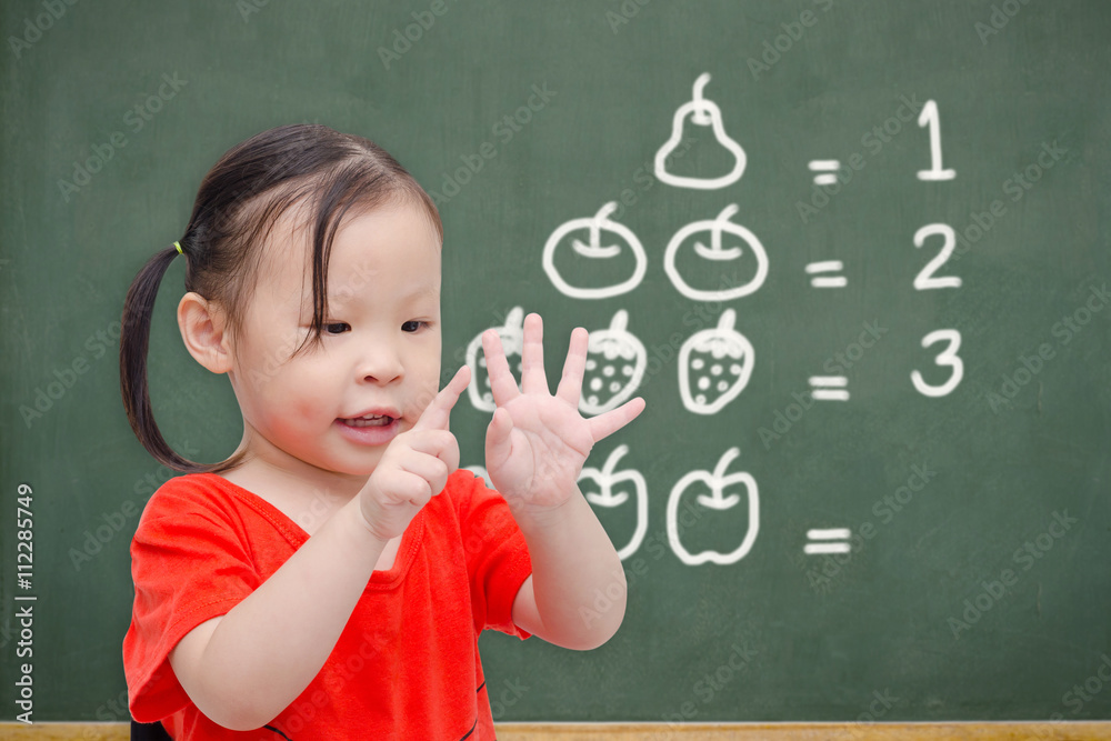 © gamelover - Little asian girl counting her finger in font of chalkboard © gamelover - Little asian girl counting her finger in font of chalkboard
