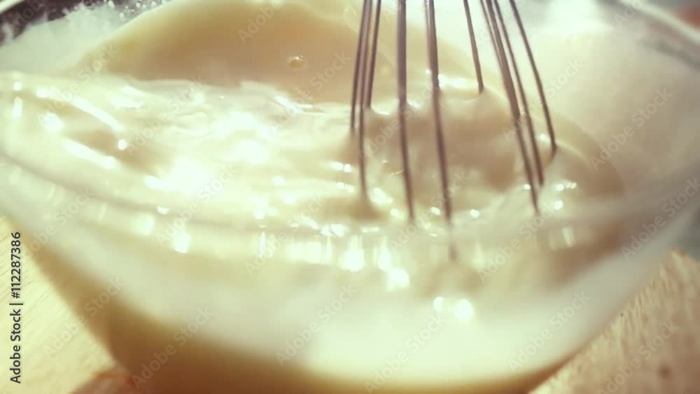 Mixing Batter or dough in slowmotion on sunny background. 1920x1080