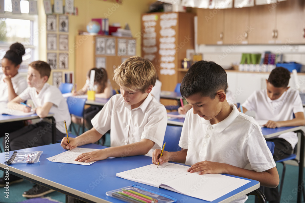 Two schoolboys working in a primary school class Two schoolboys working in a primary school class