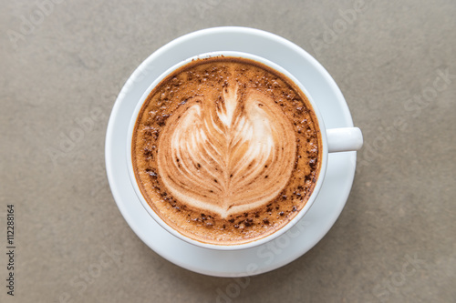 Cup of art latte on a cappuccino coffee