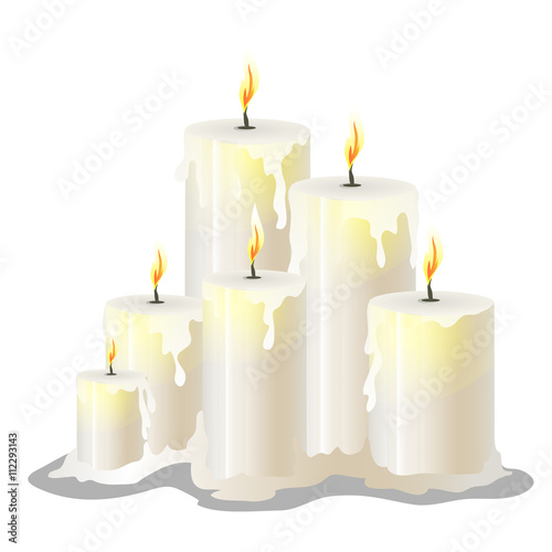 White wax cylindrical candles with a burning wick