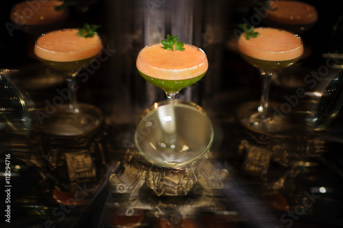 Fototapeta Naklejka Na Ścianę i Meble -  Colorfull orange and green cocktail with mint