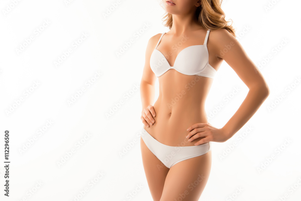 Obraz premium Close up photo of slim woman's body in white lingerie