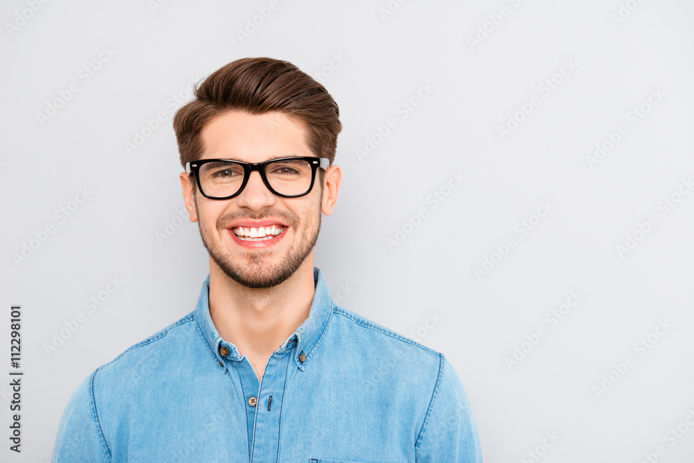Portrait of handsome cheerful young smiling man in glasses Portrait of handsome cheerful young smiling man in glasses