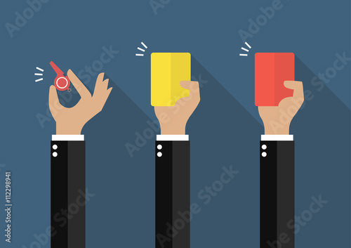 Hand of businessman showing a whistle, yellow card and red card
