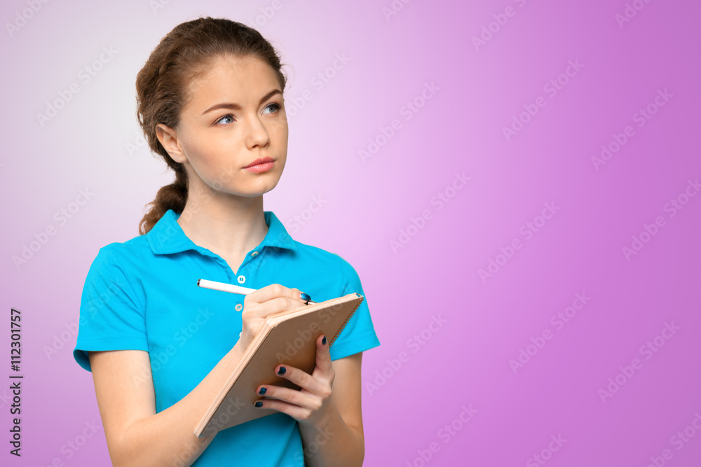 Pretty young beautiful woman standing, writing, take notes Pretty young beautiful woman standing, writing, take notes