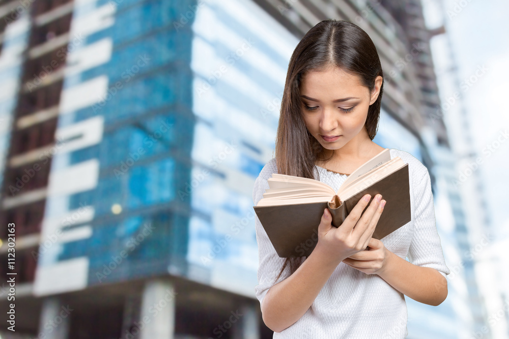 Fototapeta premium Woman university / college student holding book