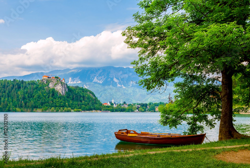 Boat on the lake with view of castle on cliff at Bled, Slovenia