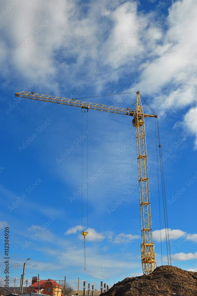 Yellow Crane Building New House on the Construction Site Yellow Crane Building New House on the Construction Site