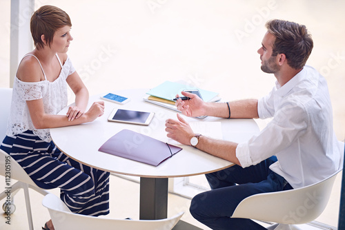 Professional consultant giving business advise to aspirational businesswoman