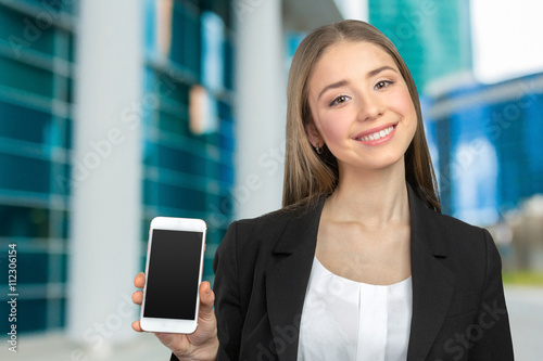 Happy pretty woman showing a blank smart phone screen Free Download Happy pretty woman showing a blank smart phone screen - GFXLoad