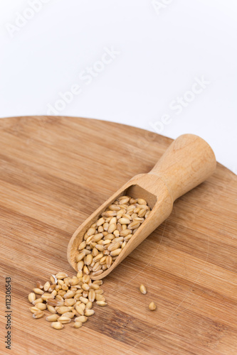 Wooden scoop full of wheat beans