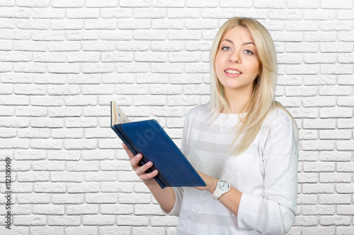 blonde businesswoman writing notes in the clipboard © fotofabrika