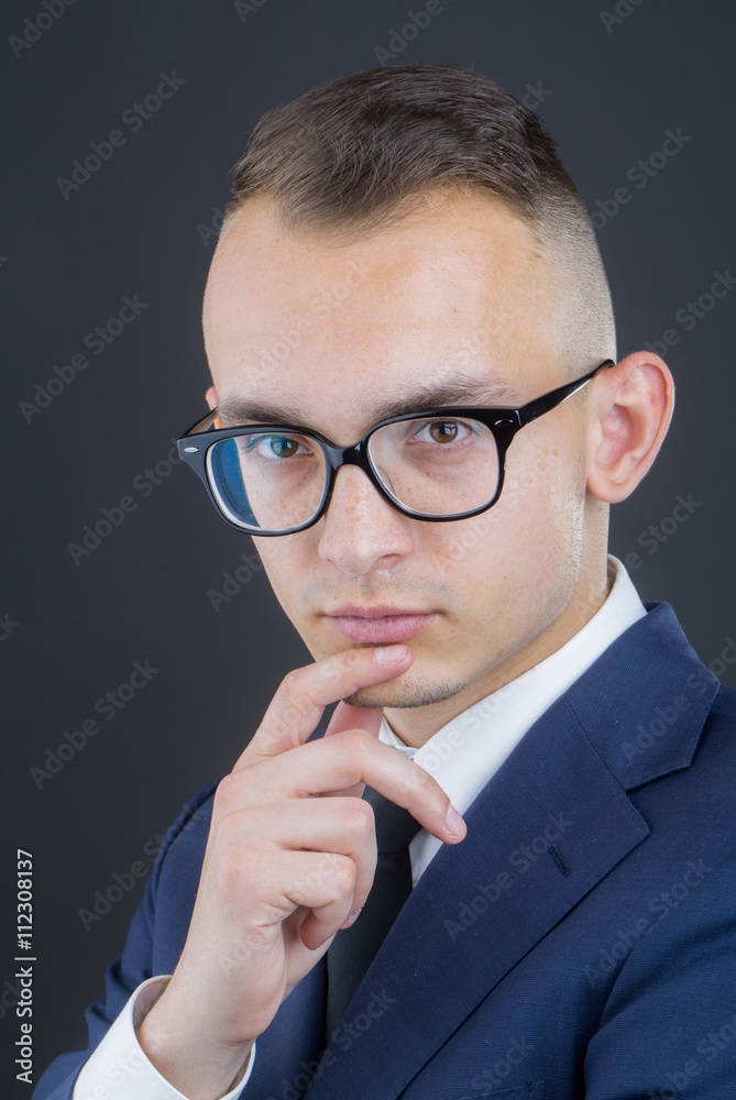 Thoughtful young guy in glasses Thoughtful young guy in glasses