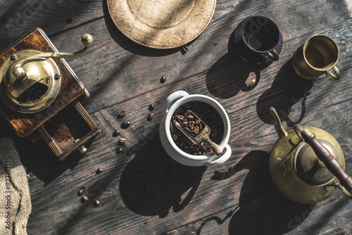 Grinding coffee with vintage coffee mill photo