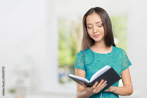 Woman university / college student holding book