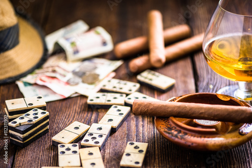 cuban cigar and domino on table