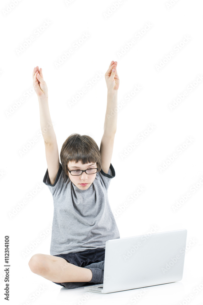 young boy with arms up in the air in grey t-shirt with laptop young boy with arms up in the air in grey t-shirt with laptop