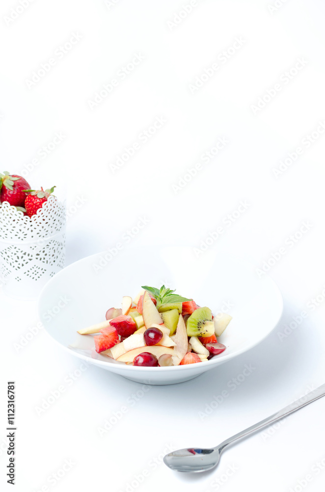Fruit salad on a white background with berry Fruit salad on a white background with berry