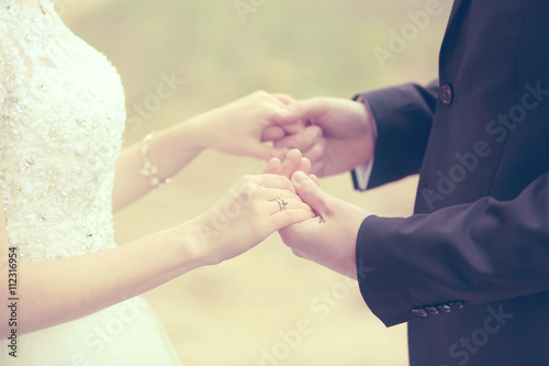 Bride and groom holding hands © Africa Studio