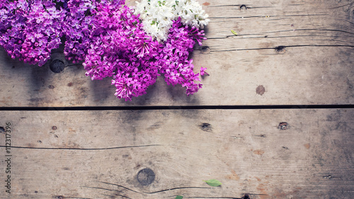 Flowers on weathered wooden background.