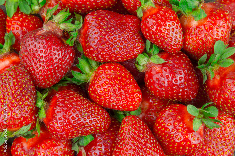 Plakat Strawberry background. Many strawberries extreme closeup.