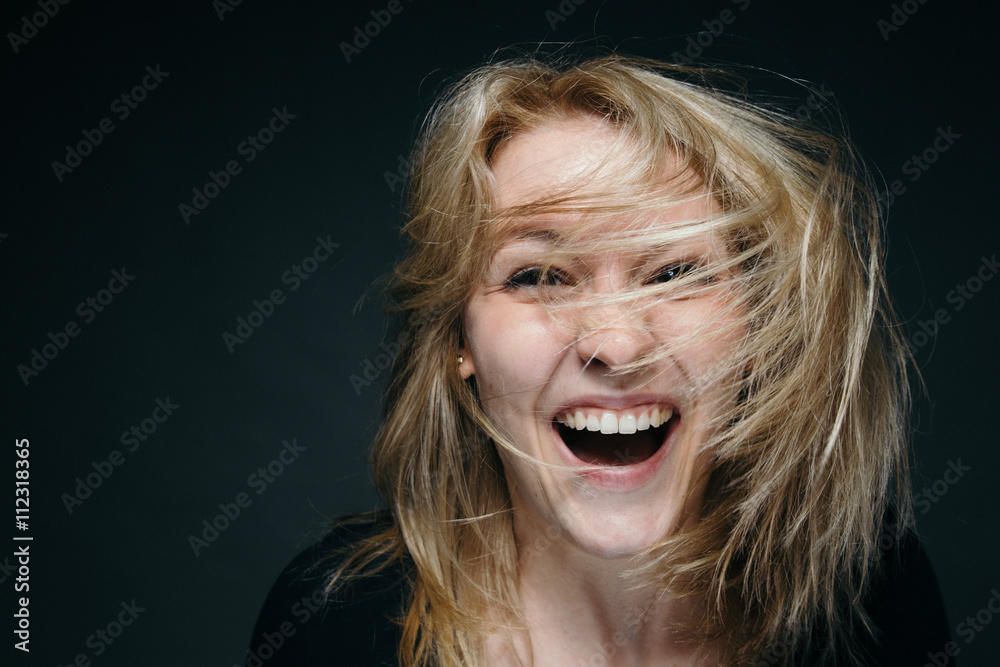 Happy smiling girl fooling around and shaking the hair Happy smiling girl fooling around and shaking the hair