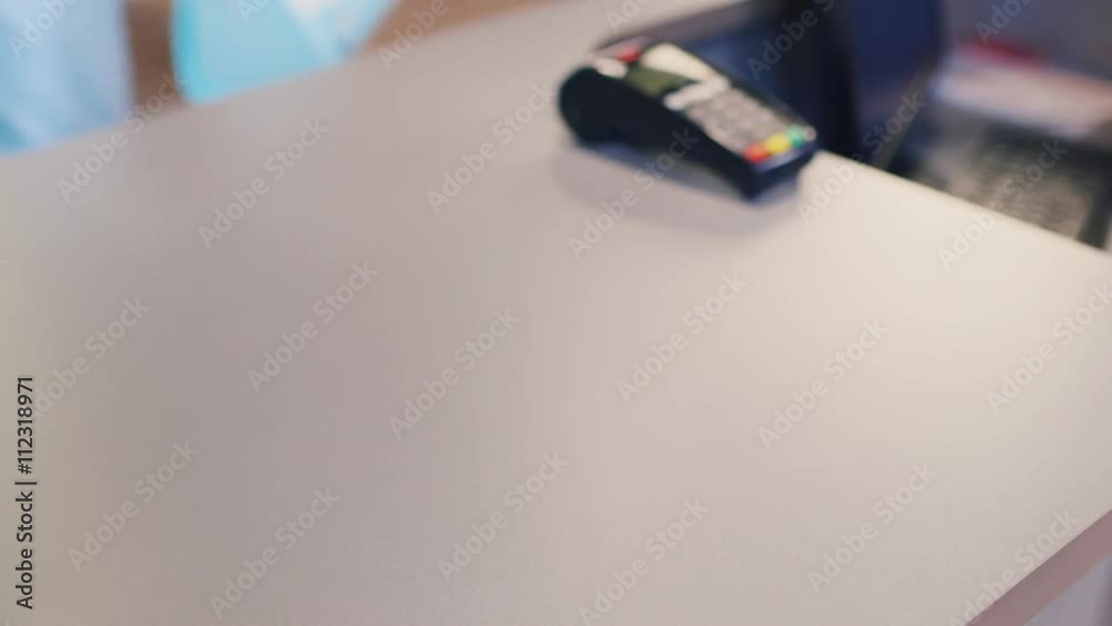Scan product codes on women's clothing. the customer service at the checkout