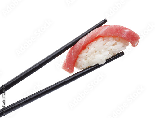 Tuna sushi nigiri in chopsticks isolated on white background