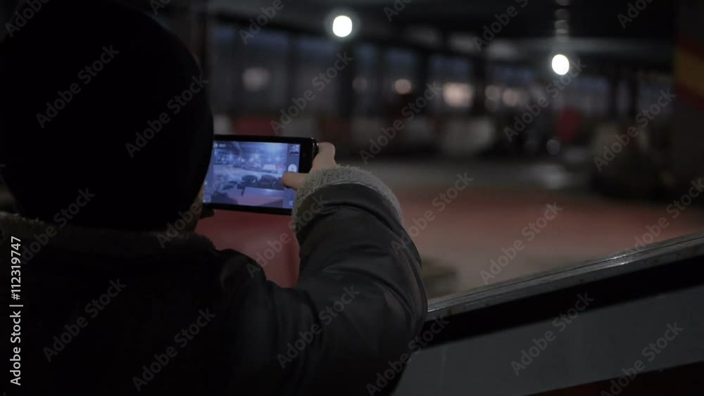 Boy shooting on the mobile phone carting ride