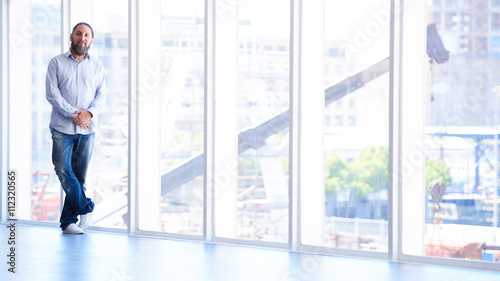 Older silvering man with beard in front of window © nakophotography