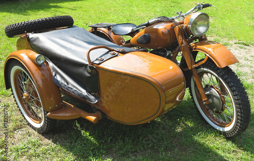 vintage motorcycle with sidecar parked on grass
