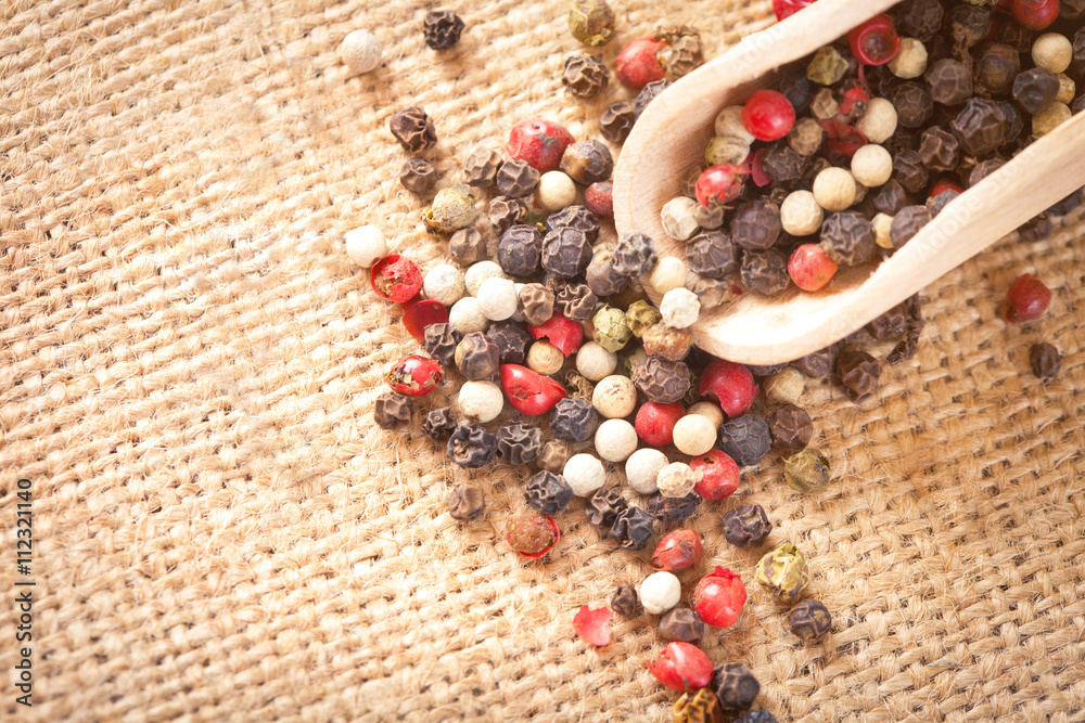 Red, white and black pepper in a spoon Red, white and black pepper in a spoon