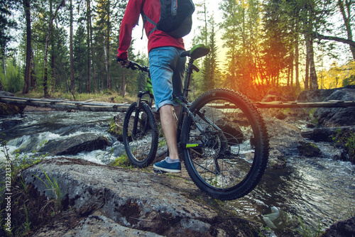 Ride on mountain bike at sunset. © Artem