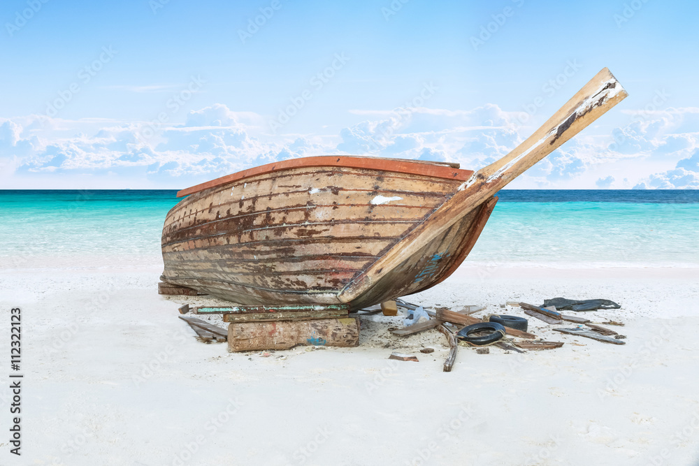 assemble fishing boat on sand with blue sky and sea