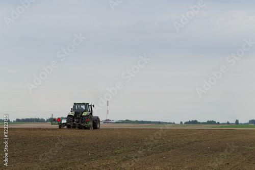 The tractor in the field on agricultural operations
