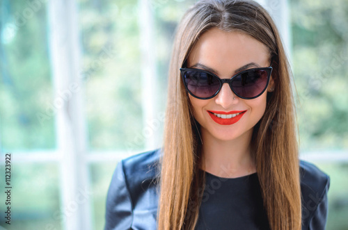 Fashion portrait stylish pretty woman in sunglasses outdoor © patramansky