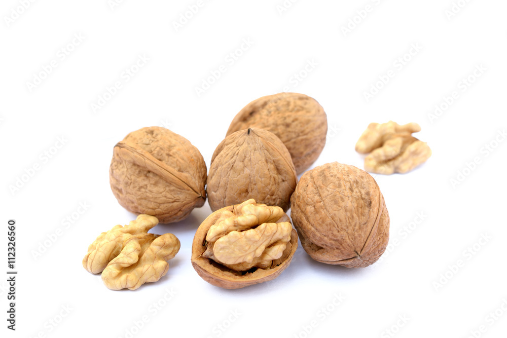 Fresh walnuts with a shell isolated on white background Fresh walnuts with a shell isolated on white background