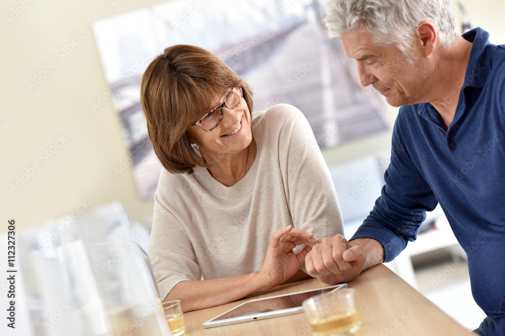 Senior couple at home using digital tablet Senior couple at home using digital tablet