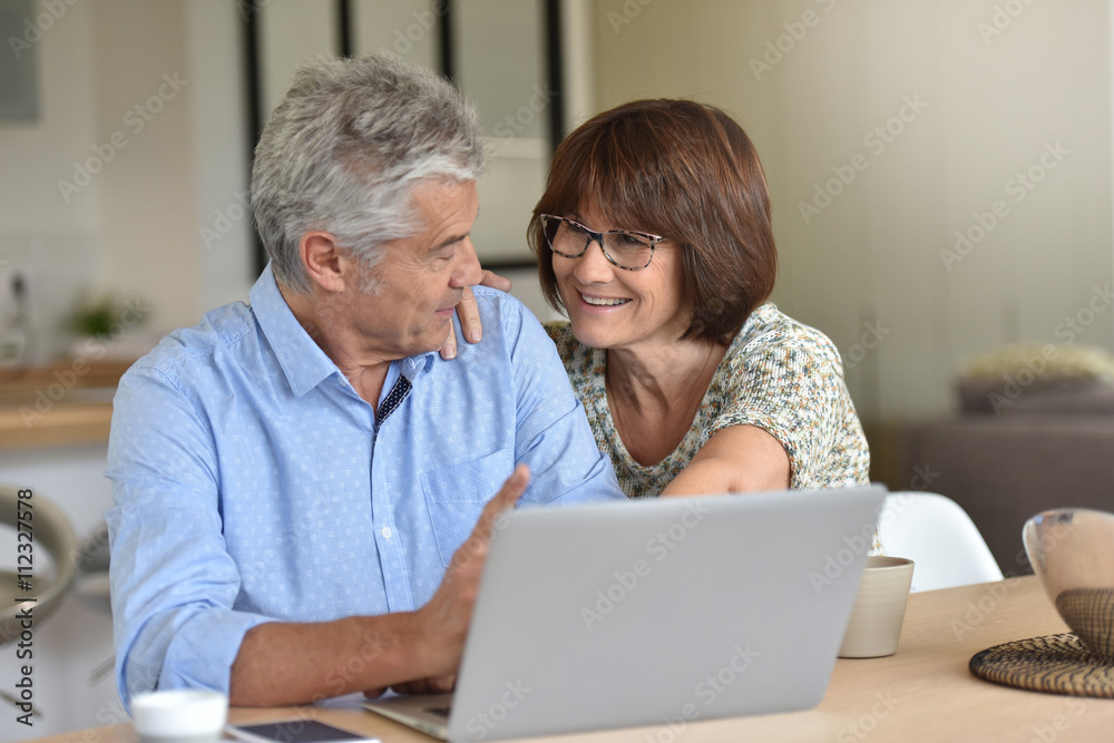 Senior couple using laptop computer at home Senior couple using laptop computer at home