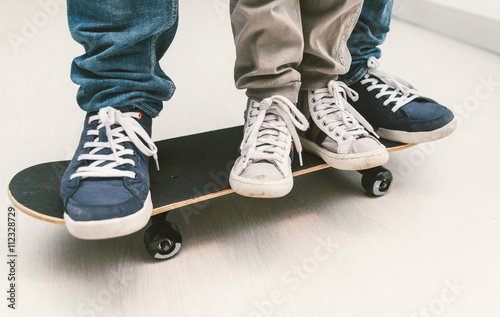 Father and son playing together on the skateboard