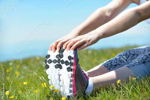 Young sports woman enjoys fitness and bright sunshine