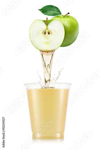 Pure apple juice pouring out from fruit in plastic cup