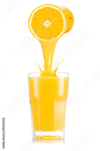 Pure orange juice pouring out from fruitin glass